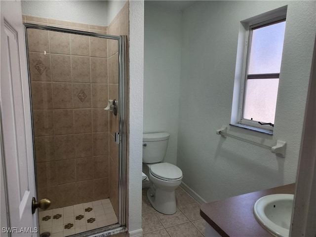 full bathroom with a textured wall, toilet, a shower stall, vanity, and tile patterned flooring