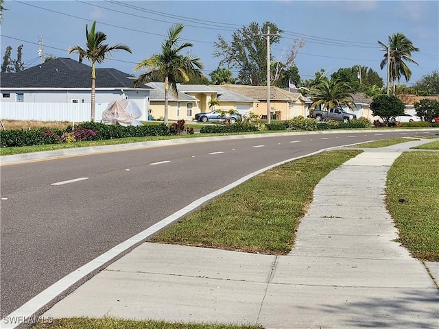 view of road with sidewalks and a residential view