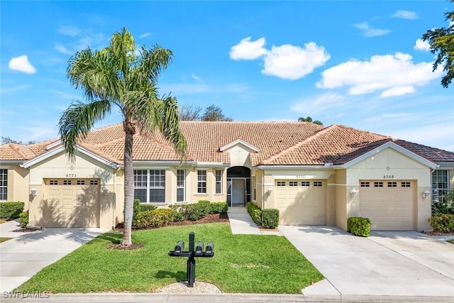 view of front of home with driveway, a tile roof, an attached garage, a front lawn, and stucco siding