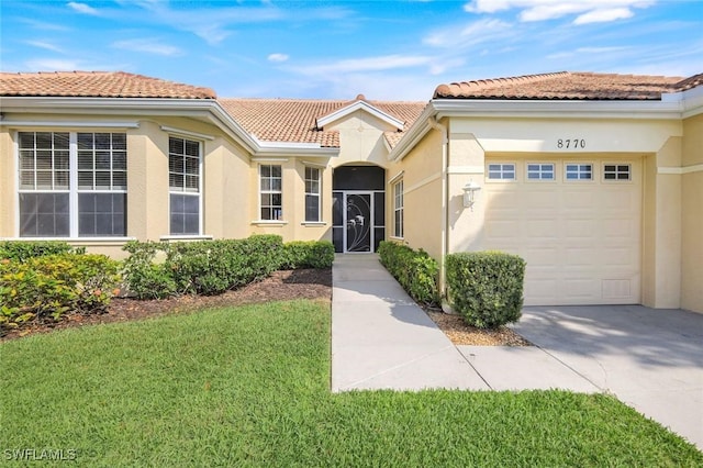 view of front of home featuring a garage, a tile roof, concrete driveway, and stucco siding