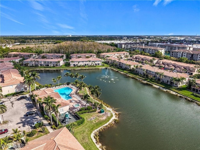 drone / aerial view with a water view and a residential view