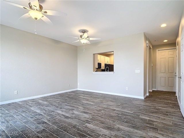 spare room with ceiling fan, dark wood-type flooring, recessed lighting, and baseboards