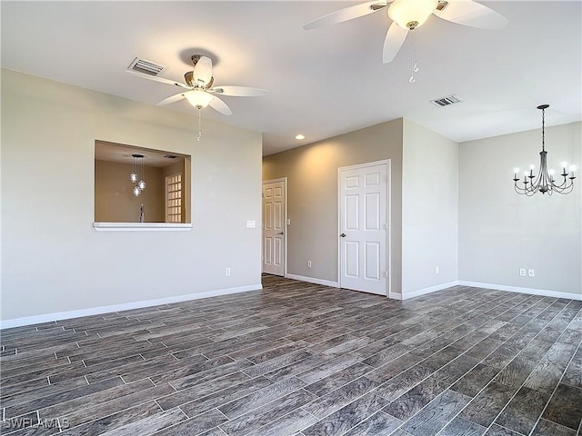 empty room featuring baseboards, visible vents, and dark wood-style flooring