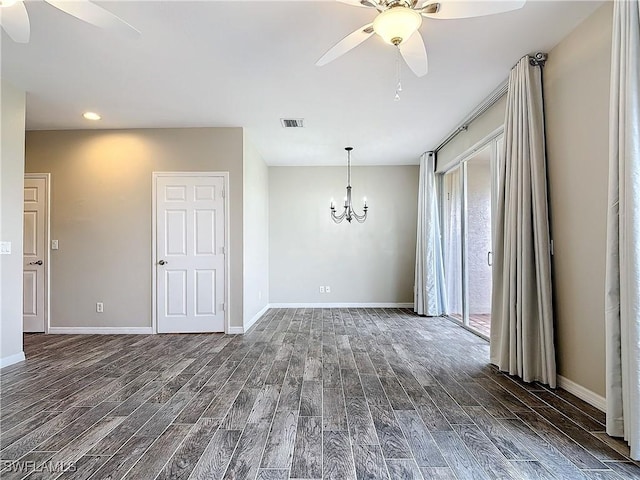 unfurnished dining area featuring dark wood-style floors, visible vents, and ceiling fan with notable chandelier