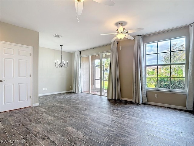 spare room with visible vents, dark wood finished floors, baseboards, and ceiling fan with notable chandelier