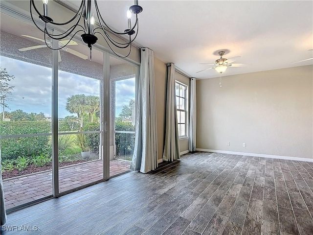 unfurnished room featuring wood finished floors, a ceiling fan, and baseboards