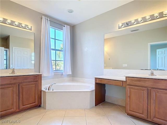 full bath featuring a garden tub, tile patterned flooring, visible vents, and a sink