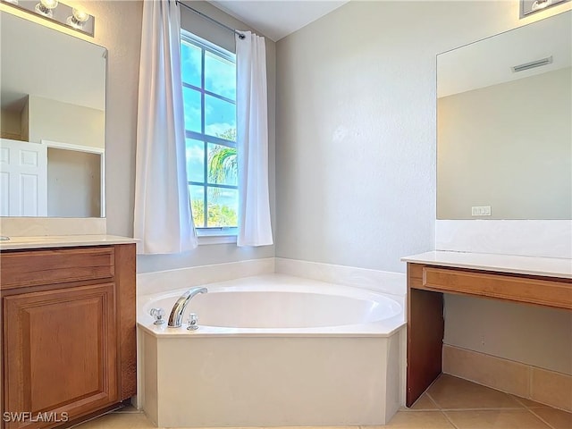 bathroom featuring tile patterned floors, visible vents, a bath, and vanity