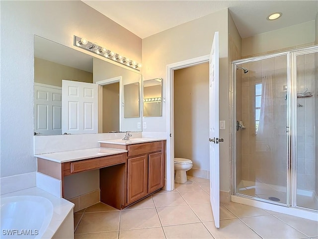 full bathroom with a stall shower, tile patterned flooring, vanity, and toilet