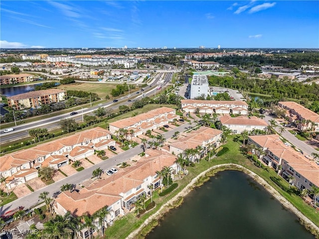 drone / aerial view featuring a water view and a residential view