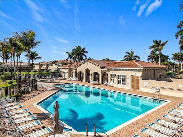 pool featuring a patio area and fence