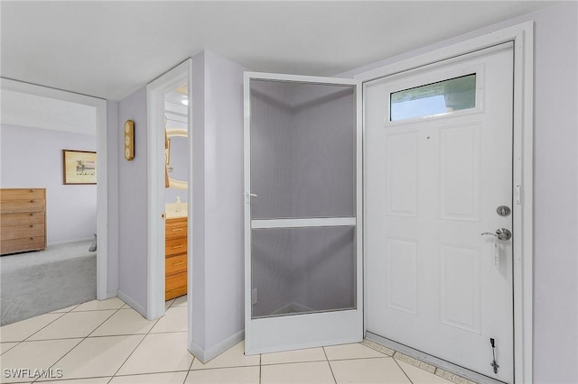 bathroom with tile patterned floors and baseboards