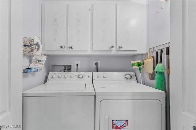 laundry room with cabinet space and washer and dryer