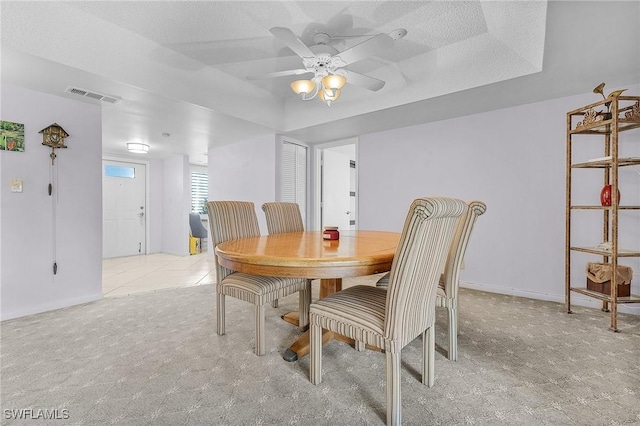 dining area with visible vents, a textured ceiling, a ceiling fan, and baseboards