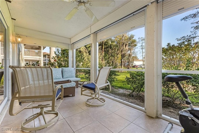 sunroom featuring a ceiling fan