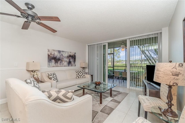 tiled living area featuring a textured ceiling, ceiling fan, and floor to ceiling windows