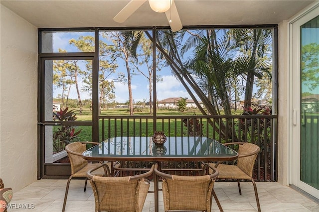 sunroom featuring a ceiling fan