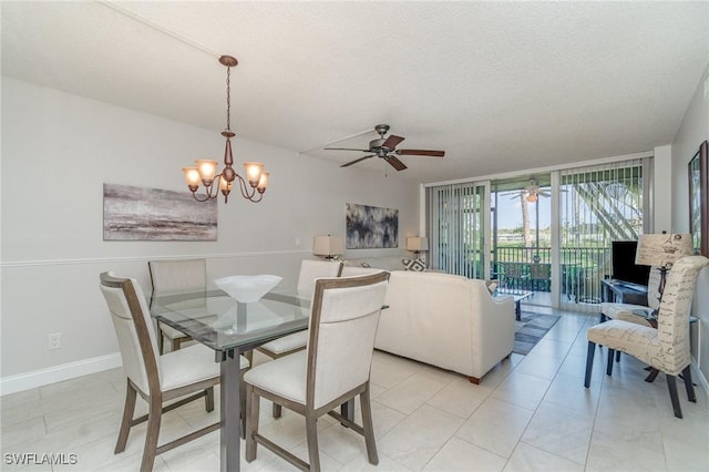 dining room with light tile patterned floors, baseboards, a textured ceiling, and ceiling fan with notable chandelier