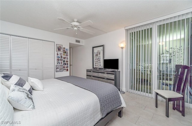 bedroom with ceiling fan, a closet, visible vents, and a textured ceiling