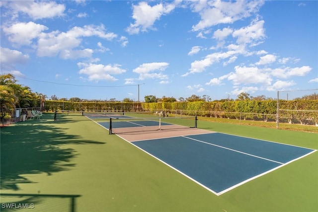 view of sport court featuring fence