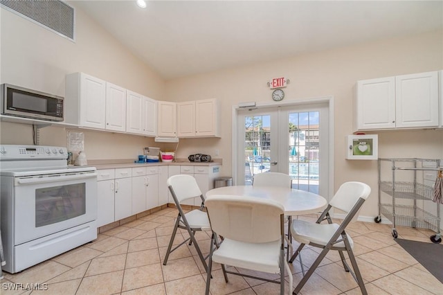 kitchen with white cabinetry, electric range, visible vents, and stainless steel microwave