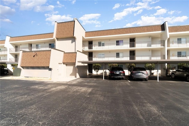 view of property featuring covered parking