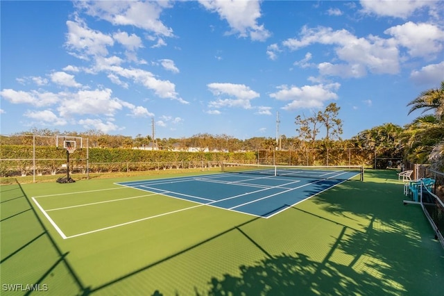 view of tennis court featuring fence