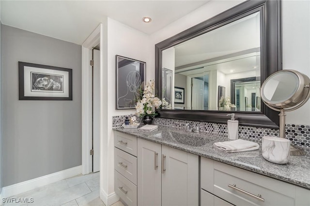 bathroom featuring tasteful backsplash, recessed lighting, vanity, baseboards, and tile patterned floors