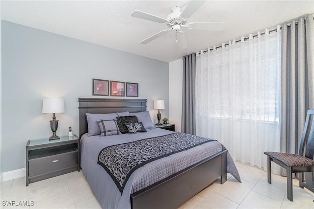 bedroom featuring a ceiling fan and light tile patterned flooring