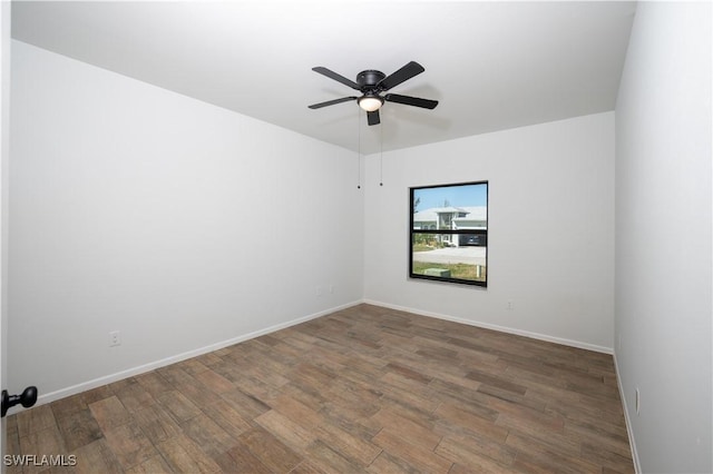 unfurnished room with ceiling fan, baseboards, and wood finished floors