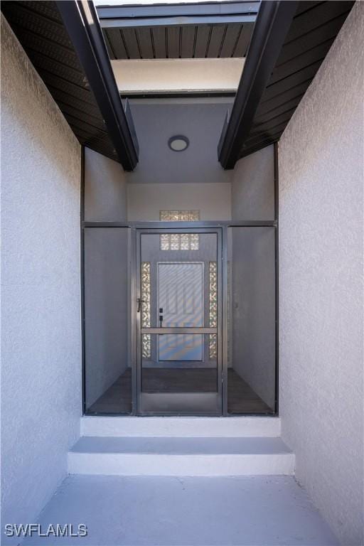 property entrance with stucco siding