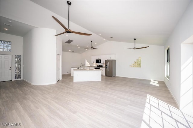 unfurnished living room featuring high vaulted ceiling, a sink, visible vents, and light wood-style floors