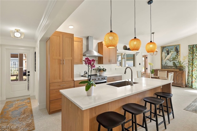 kitchen featuring crown molding, stainless steel electric stove, light countertops, a sink, and wall chimney range hood