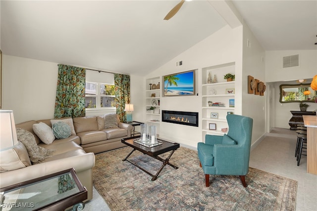 living room with built in shelves, a glass covered fireplace, visible vents, and a ceiling fan