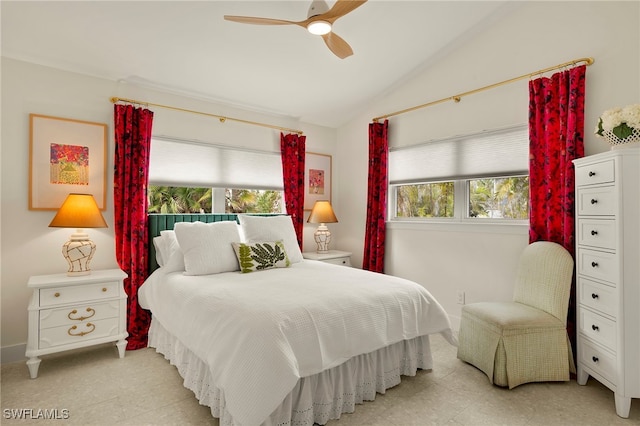 bedroom with vaulted ceiling, ceiling fan, and multiple windows