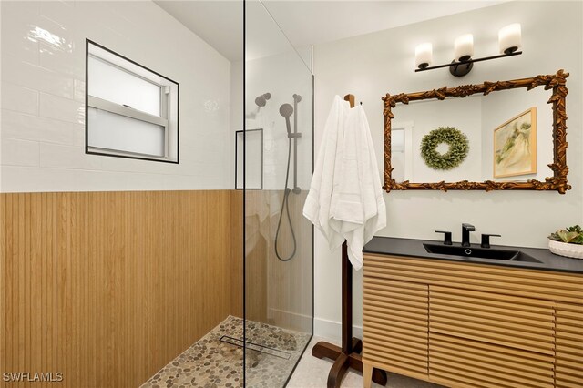 full bathroom with a walk in shower and vanity