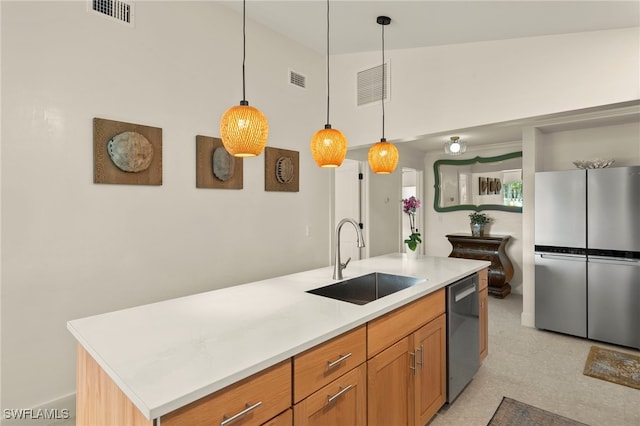 kitchen featuring light countertops, appliances with stainless steel finishes, a sink, and visible vents