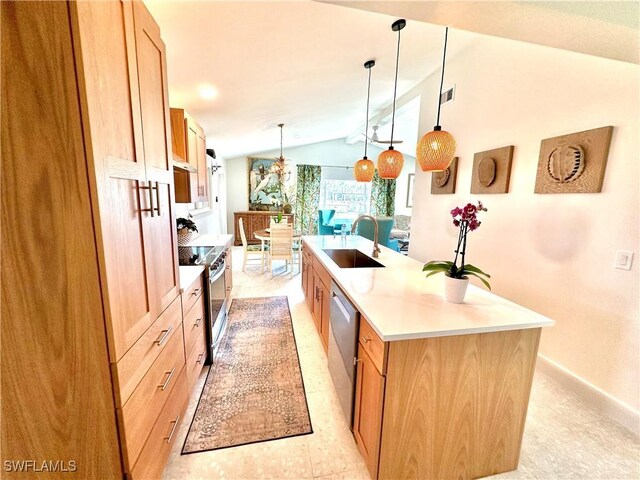 kitchen featuring lofted ceiling, light countertops, appliances with stainless steel finishes, a kitchen island with sink, and a sink