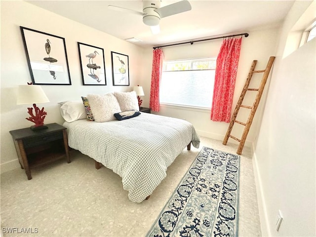 bedroom with ceiling fan and baseboards