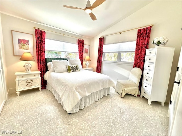 bedroom with light floors, ceiling fan, multiple windows, and vaulted ceiling