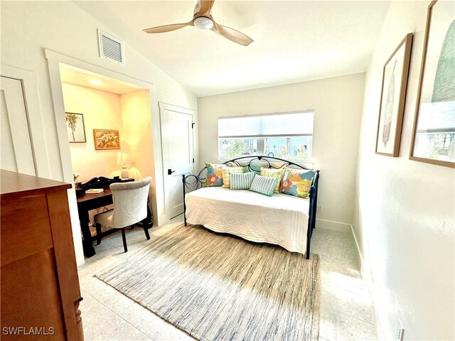 bedroom featuring lofted ceiling, ceiling fan, visible vents, and baseboards