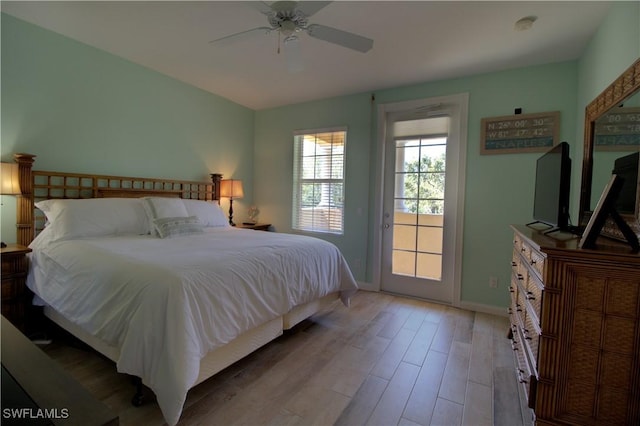 bedroom featuring a ceiling fan, access to outside, baseboards, and wood finished floors