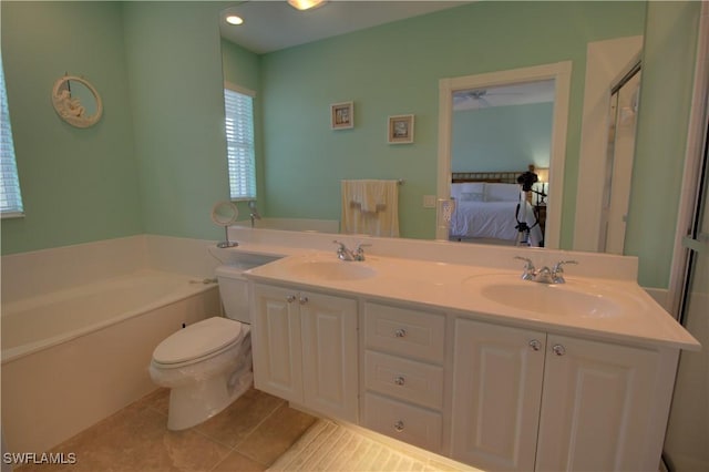 ensuite bathroom featuring a garden tub, tile patterned floors, a sink, and connected bathroom