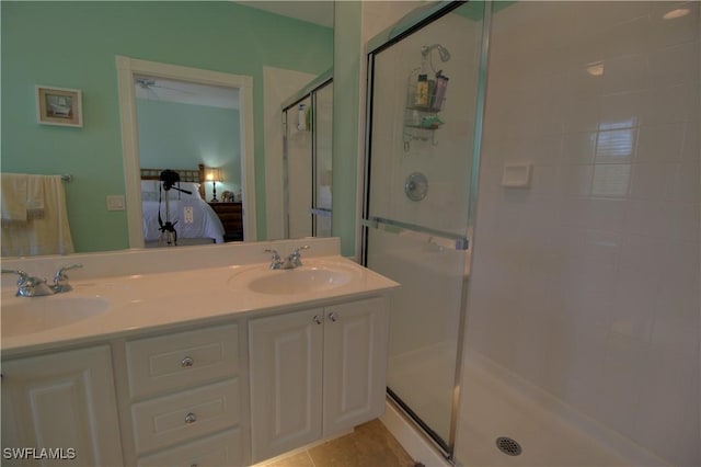 full bath with double vanity, a stall shower, connected bathroom, and a sink