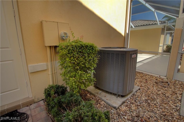 exterior details with electric meter, central AC unit, and stucco siding