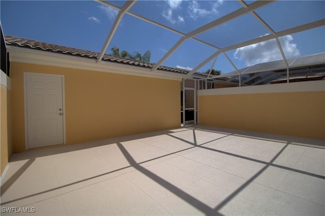 view of patio with glass enclosure