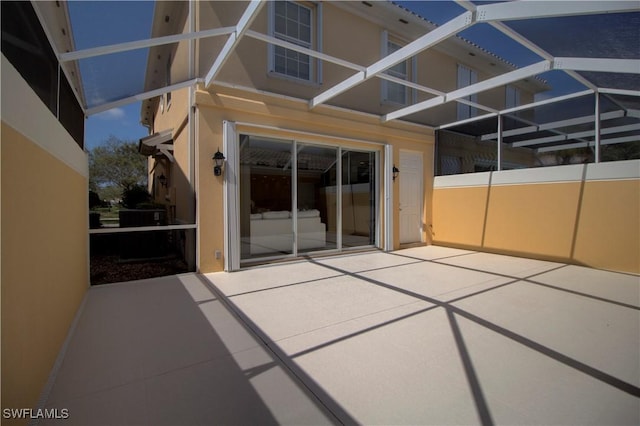 view of patio featuring a lanai