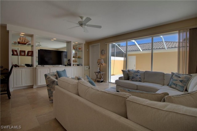 living area with light tile patterned floors and a ceiling fan