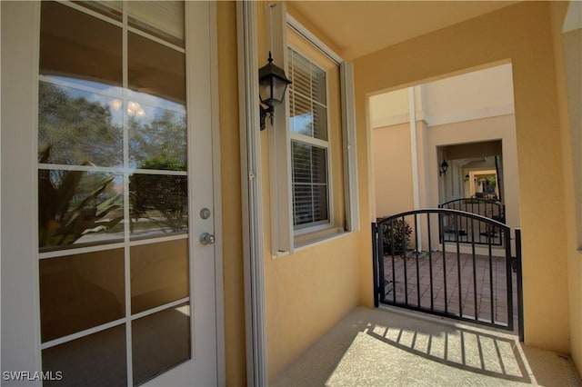 entrance to property featuring stucco siding