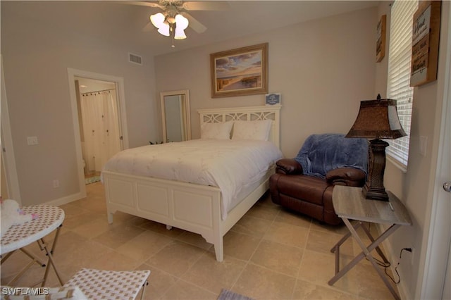 bedroom with a ceiling fan, visible vents, and baseboards